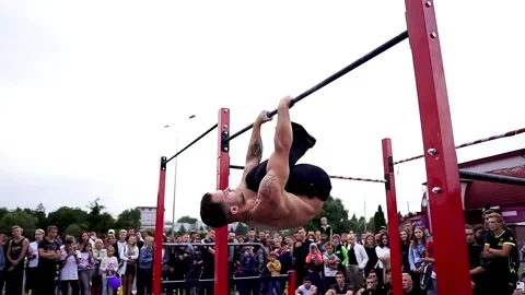 Young athletes show acrobatic stunts on the crossbar Stock Footage 170066703