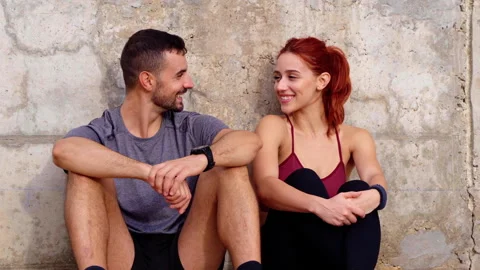 Young athletes taking a break chatting about their workout routines. Stock Footage 276411966