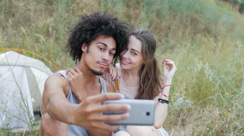 Young, athletic, attractive mixed race couple relaxing in nature Stock Footage 57103878