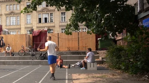 Young athletic boy is making workout jumping the rope, in a city park in Berlin Stock Footage 114176768