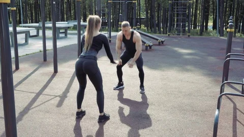 Young athletic couple doing exercises outdoors Stock Footage 111967636