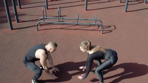 Young athletic couple doing exercises outdoors Stock Footage 112085332