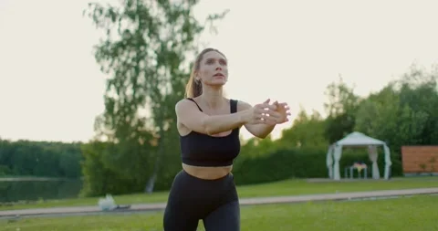 Young athletic girl does exercises to train her legs. Squat workout Stock Footage 205575603