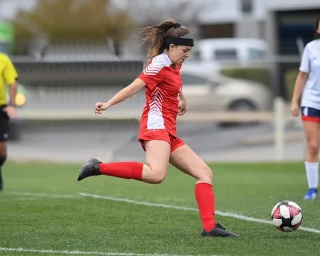 Young Athletic Girls Making Great Plays During a Soccer Game Stock Photos