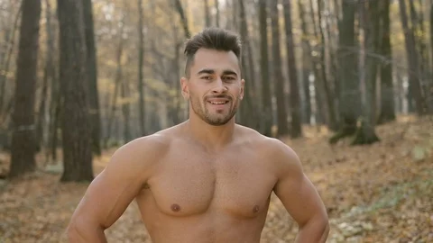 Young Athletic Guy With Naked Torso Stands In The Woods. Stock Footage 120651522