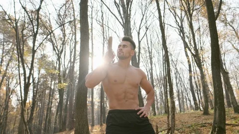 Young Athletic Guy With Naked Torso Stands In The Woods With An Ax On His Stock Footage 120652219