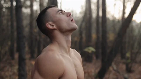 Young Athletic Guy With Naked Torso Stands In The Woods And Does Breathing Stock Footage 125852940