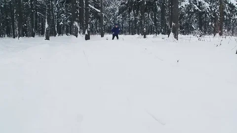 A young athletic guy steps on huge snowdrifts Stock Footage 76598533