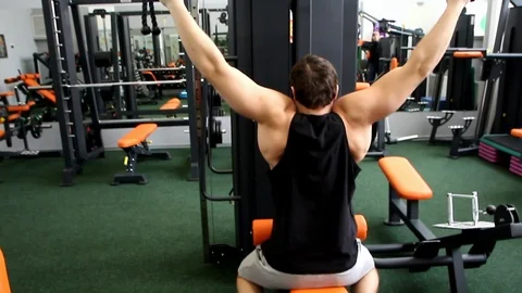 Young athletic guy trains his back overall Stock Footage 115624309