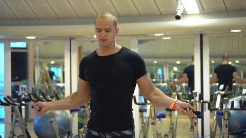 Young athletic guy trains with a jumping rope in gym in slow mo Stock Footage 109063600