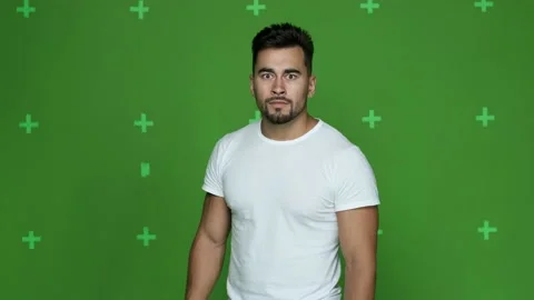 Young athletic guy in white t-shirt shows fear Stock Footage 130831443