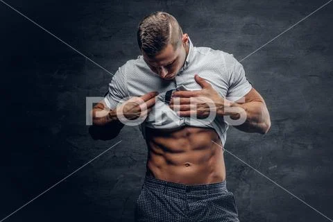 Young athletic male shows six pack ABS. Stock Photos