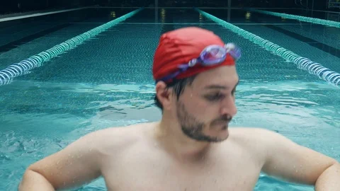Young athletic man (25-30) takes deep breaths after strenuous swim exercise Stock Footage 109184291