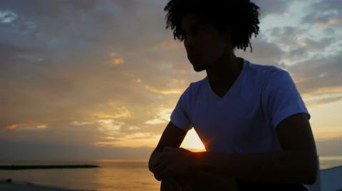 Young athletic man doing gymnastics on the sea early in the morning Stock Footage 50205103