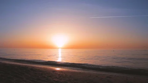 Young athletic man doing gymnastics on the sea early in the morning 動画素材 75520595