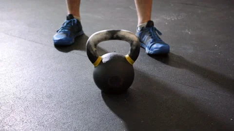 Young athletic man doing kettlebell swing during gym workout Stock Footage 65280271