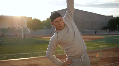 Young athletic man doing warm-up before exercise and jogging Stock Footage 64019195