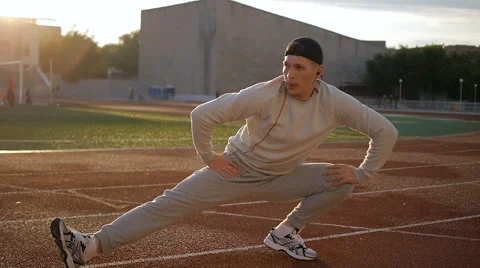 Young athletic man doing warm-up before exercise and jogging Video stock 64019297