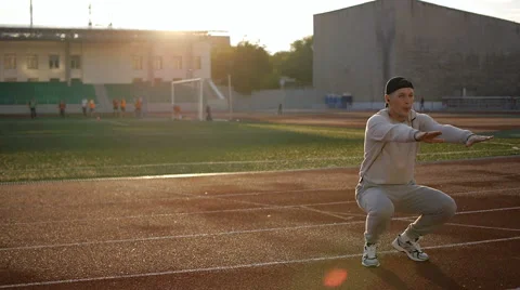 Young athletic man doing warm-up before exercise and jogging Stock Footage 64019389