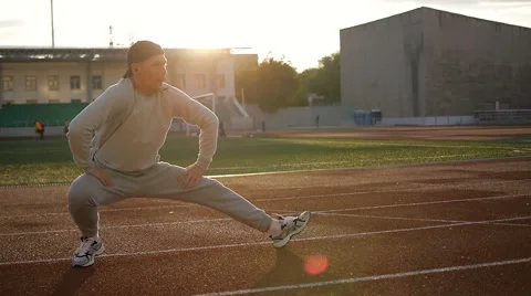 Young athletic man doing warm-up before exercise and jogging Stock Footage 64019506