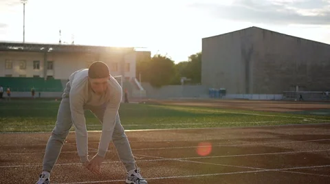Young athletic man doing warm-up before exercise and jogging Video stock 64019690