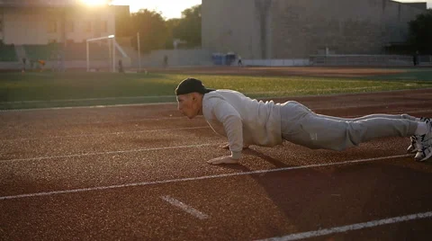 Young athletic man doing warm-up before exercise and jogging Stock Footage 64020768