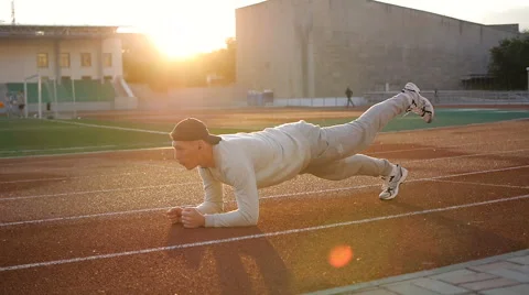 Young athletic man doing warm-up before exercise and jogging Stock-Footage 64021632