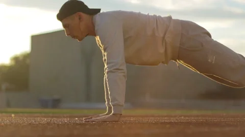 Young athletic man doing warm-up before exercise and jogging Stock Footage 64022240