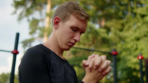 Young athletic man doing a wrist warm up before training at an outdoor gym... Stock Footage 341729462