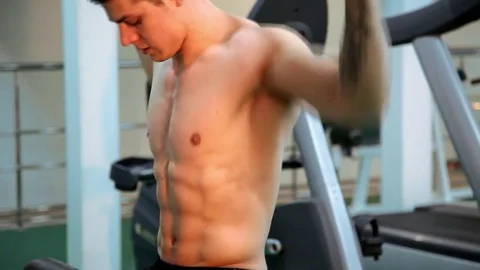 Young athletic man execute  muscle exercises Stock Footage 74113919