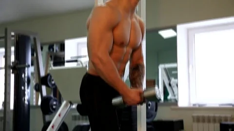 Young athletic man execute  muscle exercises Stock Footage 74295334