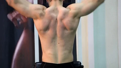 Young athletic man execute  muscle exercises Stock Footage 74295339