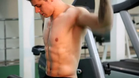 Young athletic man execute  muscle exercises Stock Footage 74404995