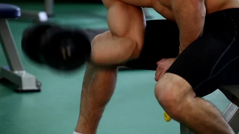 Young athletic man execute  muscle exercises Stock Footage 74404996