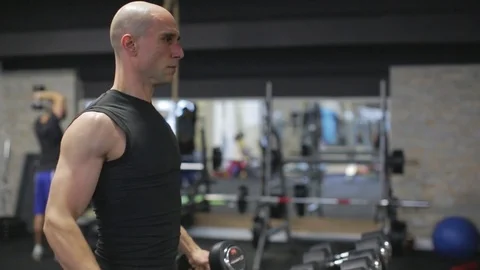 Young athletic man exercise shoulder, dumbbell flys Stock Footage 71606499