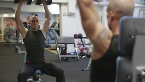 Young athletic man exercise shoulder, military shoulder press Stock Footage 71607570