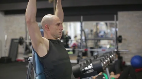 Young athletic man exercise shoulder, military shoulder press Stock Footage 71609559