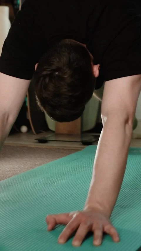 A young, athletic man exercises at home Vídeo Stock 335209742
