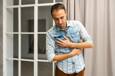 Young athletic man has a sudden heart attack Stock Photos