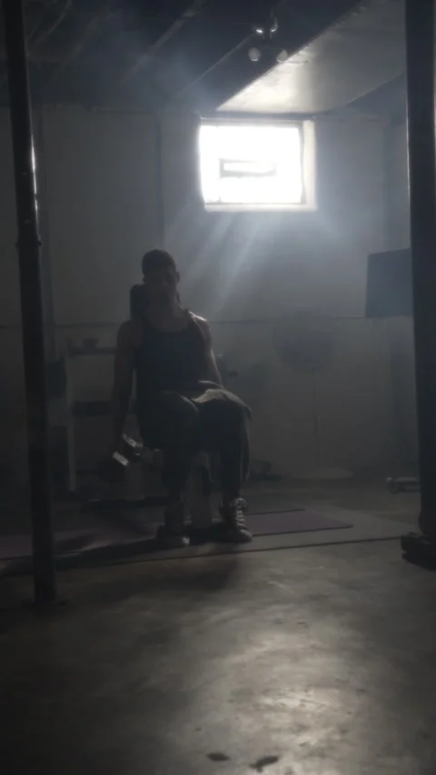 Young athletic man lifting weights for biceps during an intense workout session Stock Footage 344168494