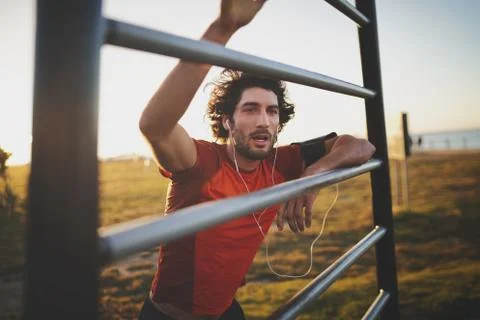 Young athletic man taking a break from training standing with hands on vertical Stock Photos