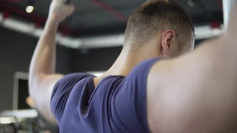 A young athletic man is training in the gym. 4K Stock Footage 73781413