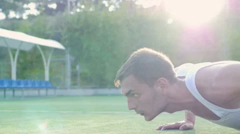 Young athletic man trains on the playground outdoors Stock Footage 56228949