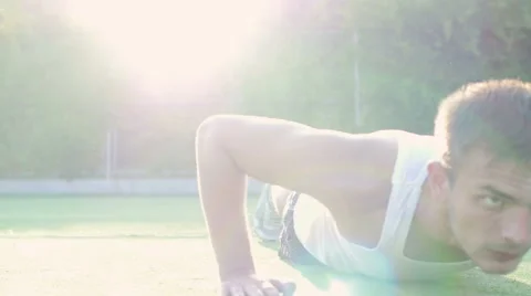 Young athletic man trains on the playground outdoors Stock Footage 56228976
