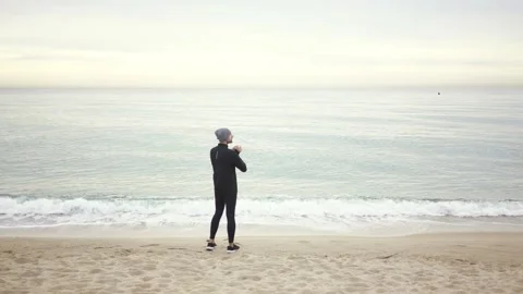 Young athletic man warming up before workout at seaside Stock Footage 132042052