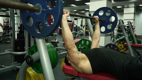 Young athletic man workout with heavy barbell in gym sport muscle training Stock Footage 93503635