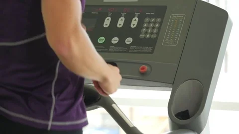 Young athletic men running on treadmill in sport gym close up Stock Footage 77760642