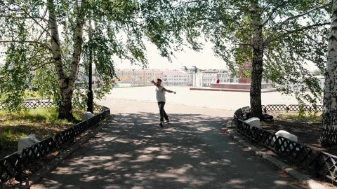 A young athletic tattooed man dancing in the square on the background of the Stock Footage 112570659