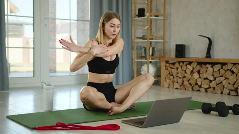 Young athletic trainer explains how to perform stretching exercises online Video stock 242105636