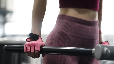 Young athletic woman doing exercise for training triceps dips on parallel bars Video stock 285118919